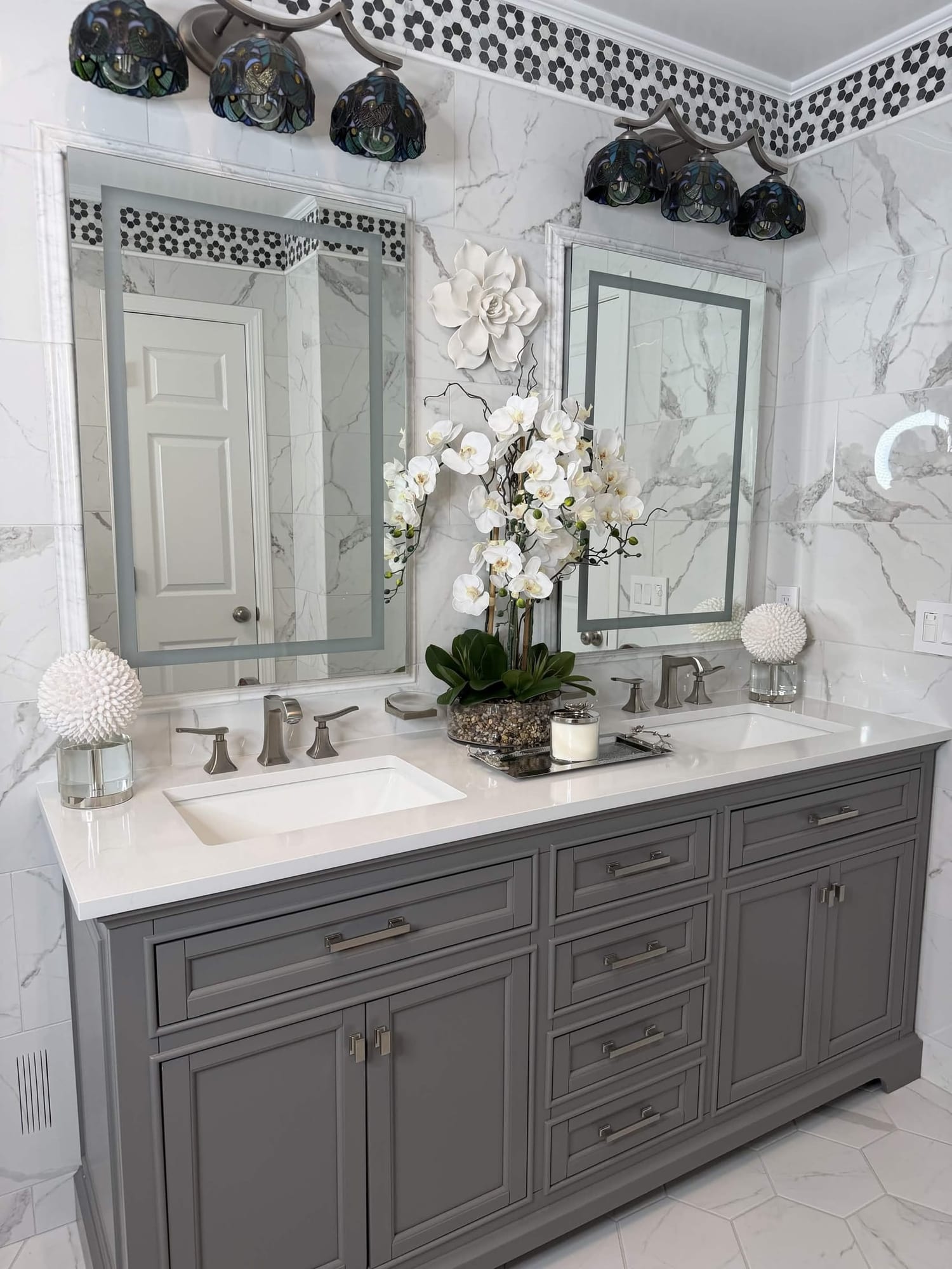 Marble bathroom with gray double vanity, quartz tops and brushed nickel fixtures in the Capital Region