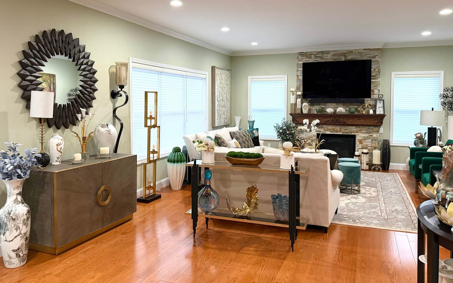 Renovated open living room with hardwood floors, stone fireplace and custom millwork