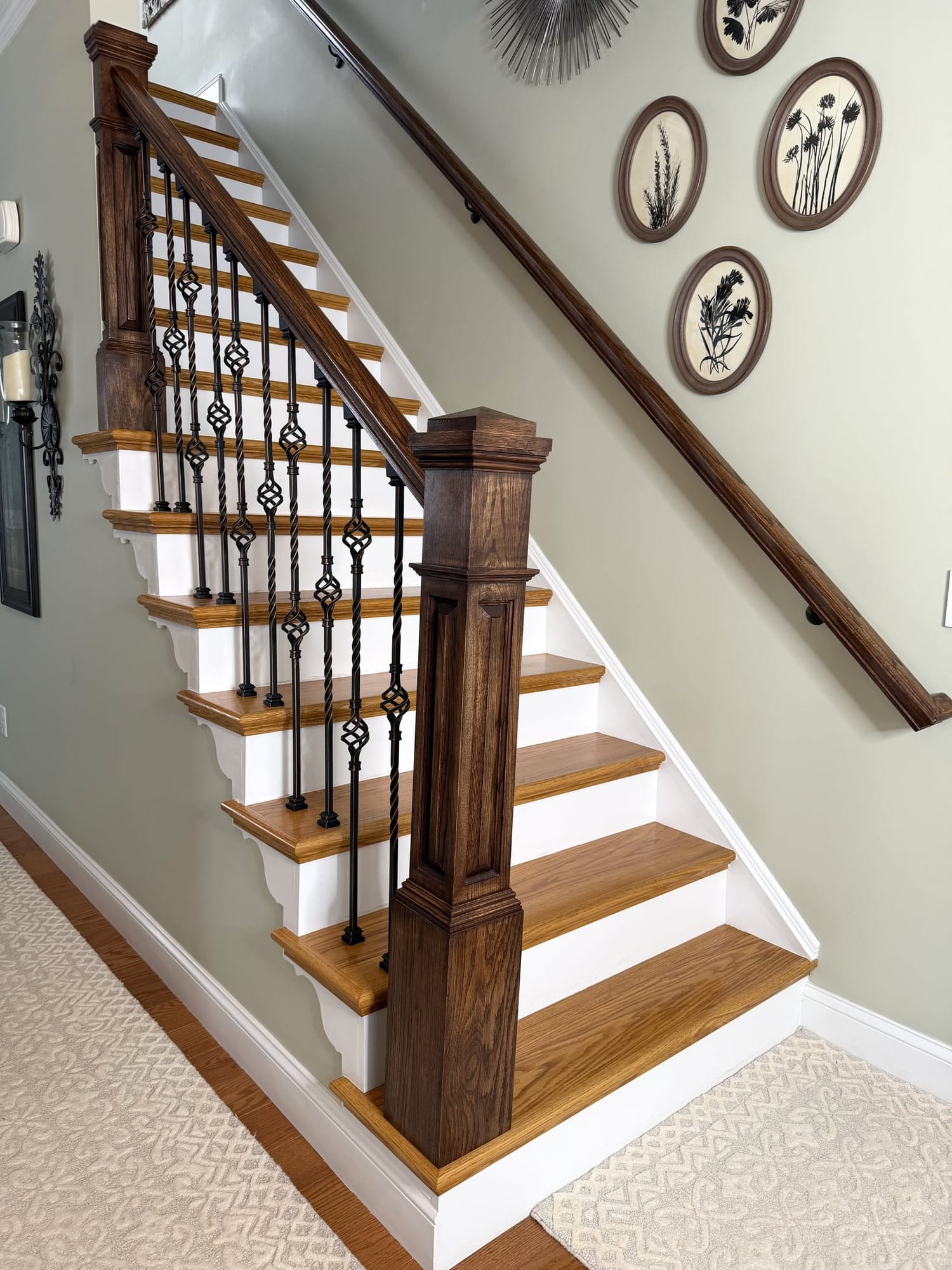 Oak staircase with stained treads and wrought iron balusters